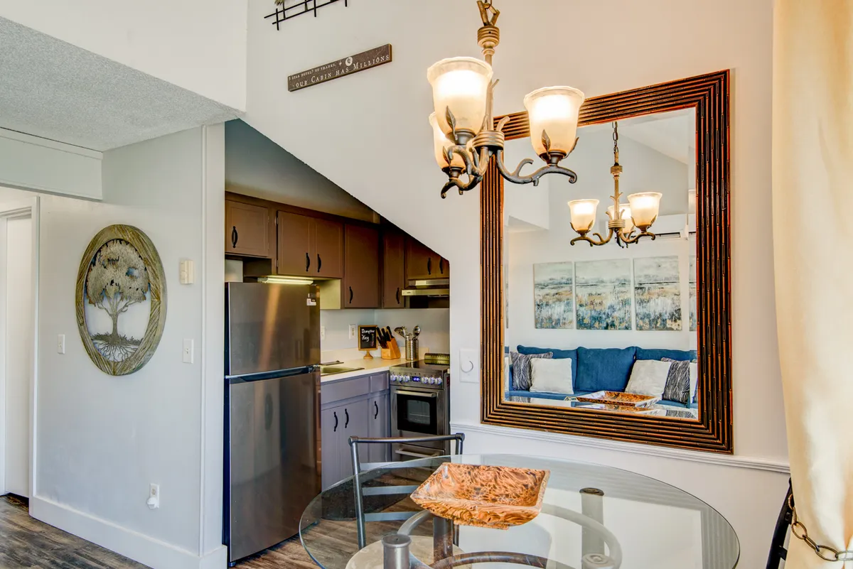 A stylish dining table sits under a charming chandelier, surrounded by comfortable seating and tasteful decor. The setup is perfect for family feasts, intimate dinners, or casual morning breakfasts, reinforcing the section's emphasis on shared meals in an inviting atmosphere.